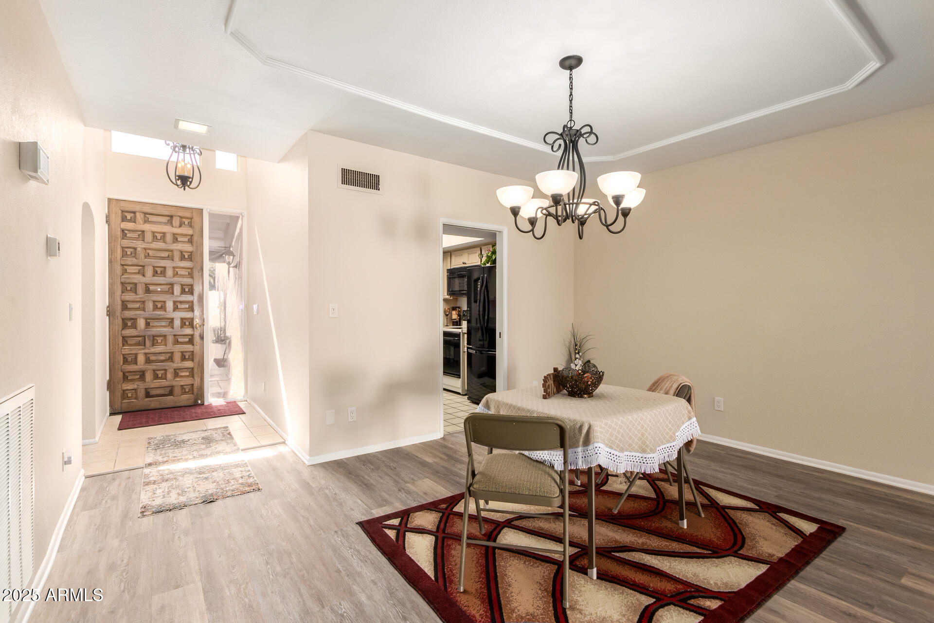 6735 North 16th Place Phoenix, AZ 85016 - Photo 14 of 28 a dining room with furniture a chandelier and wooden floor