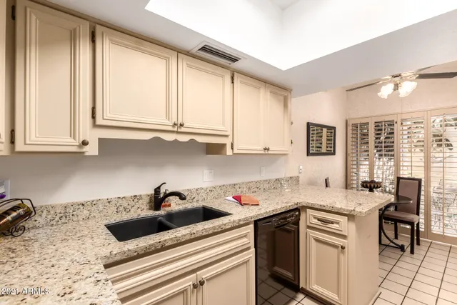 a kitchen with stainless steel appliances sink cabinets and window