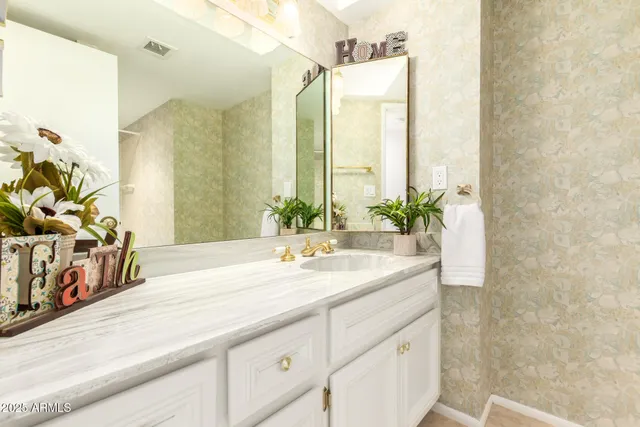 a bathroom with a granite countertop sink and a mirror
