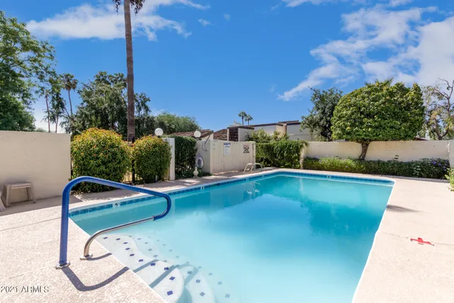 a view of a swimming pool with a yard