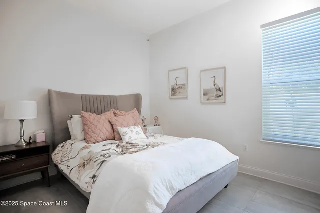 a bedroom with a bed and a night stand