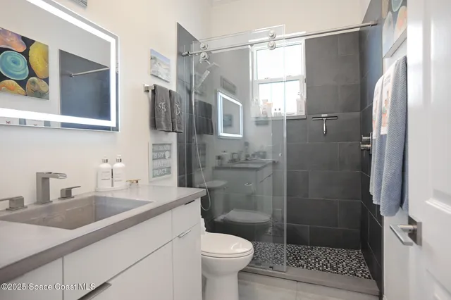 a bathroom with a sink toilet and shower