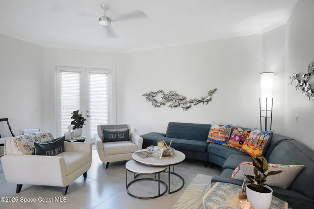 a living room with furniture and a potted plant