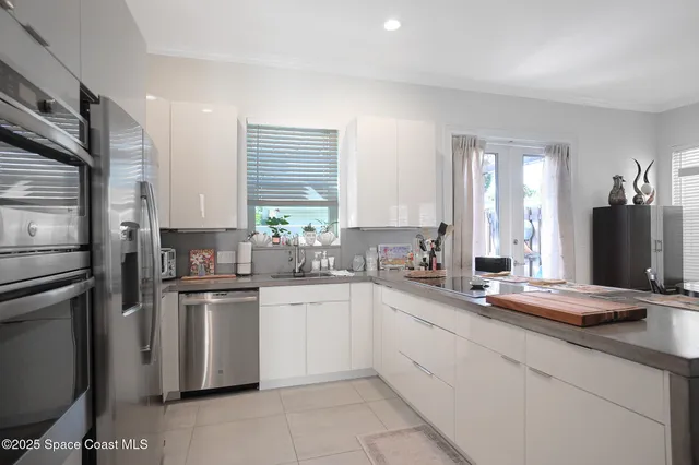 a kitchen with a sink cabinets and stainless steel appliances