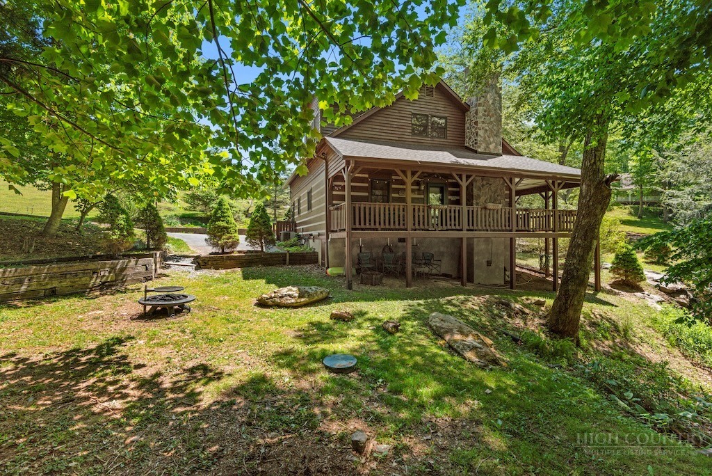 339 Welcome Way Boone, NC 28607 - Photo 2 of 20 a backyard of a house with yard and outdoor seating