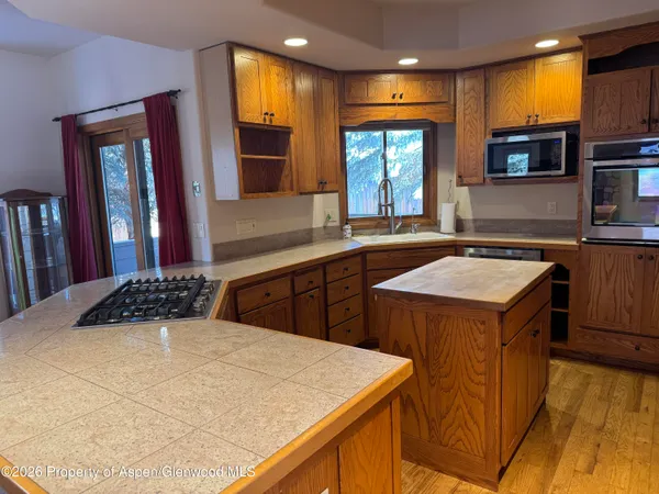 a kitchen that has a sink and a stove in it
