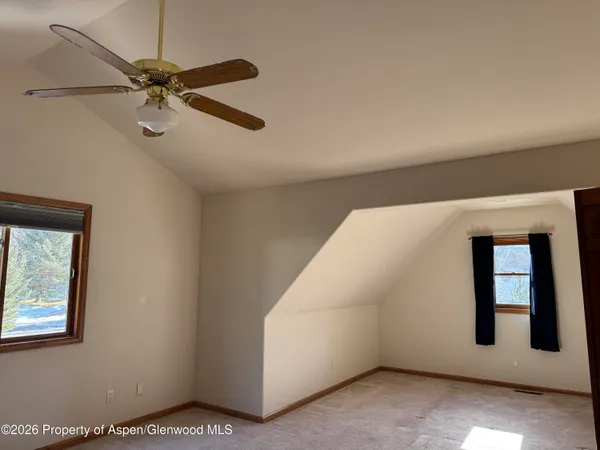 a view of room with window and a ceiling fan