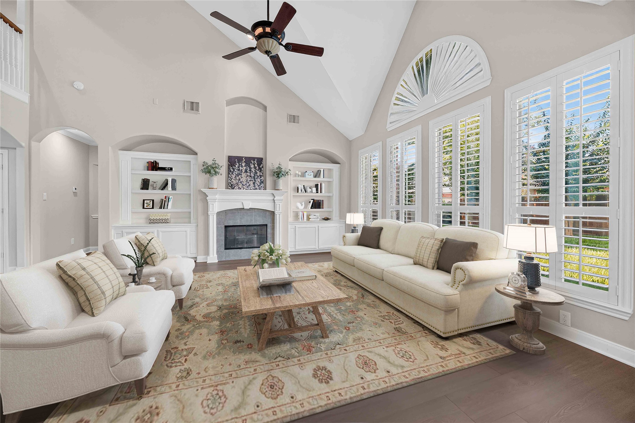 3303 Raleigh Row Missouri City, TX 77459 - Photo 10 of 50 Spacious living room with high vaulted ceilings, elegant fireplace, built-in shelving, and abundant natural light from large windows with plantation shutters.