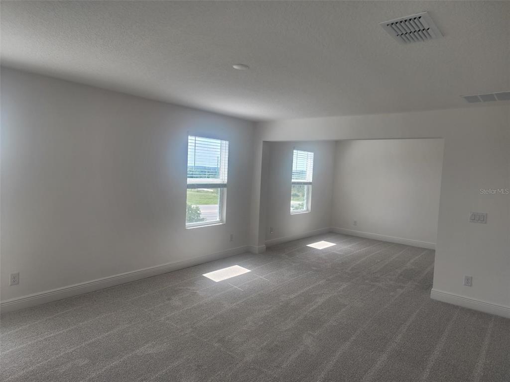 7501 Catania Loop Clermont, FL 34714 - Photo 8 of 12 an empty room with windows and closet