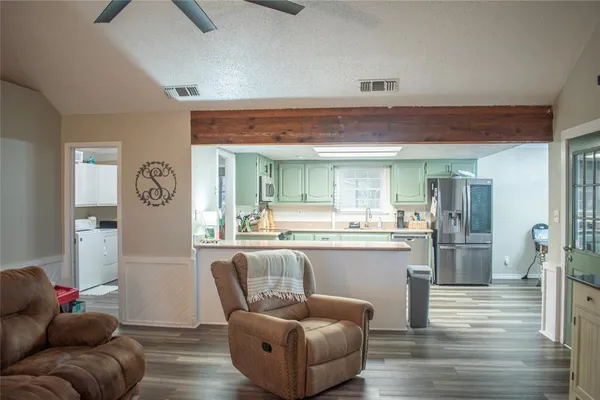 a kitchen with lots of counter top space and stainless steel appliances