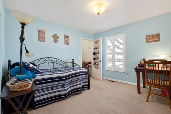 a bedroom with furniture and a window