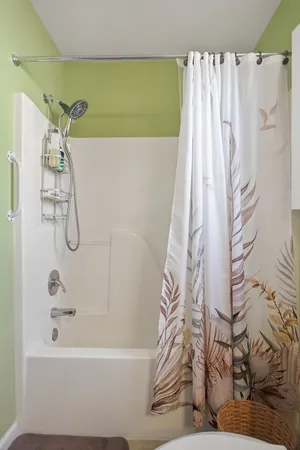 a bathroom with a shower curtain and a bathtub
