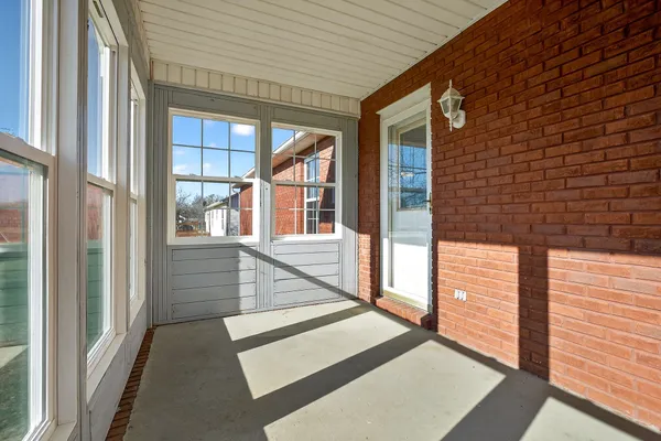 a view of a balcony with large windows