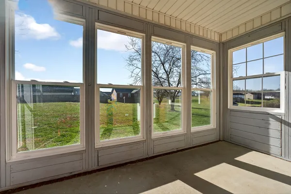 a view of front door and porch with a floor to ceiling window