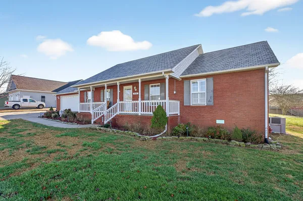 a view of a house with backyard and porch
