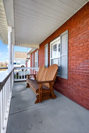 a balcony with furniture and a gate