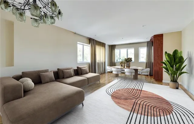 a living room with furniture a rug and a window