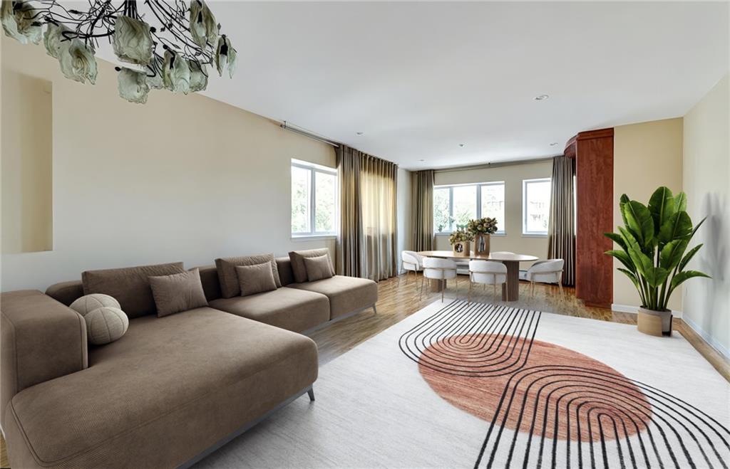 a living room with furniture a rug and a window