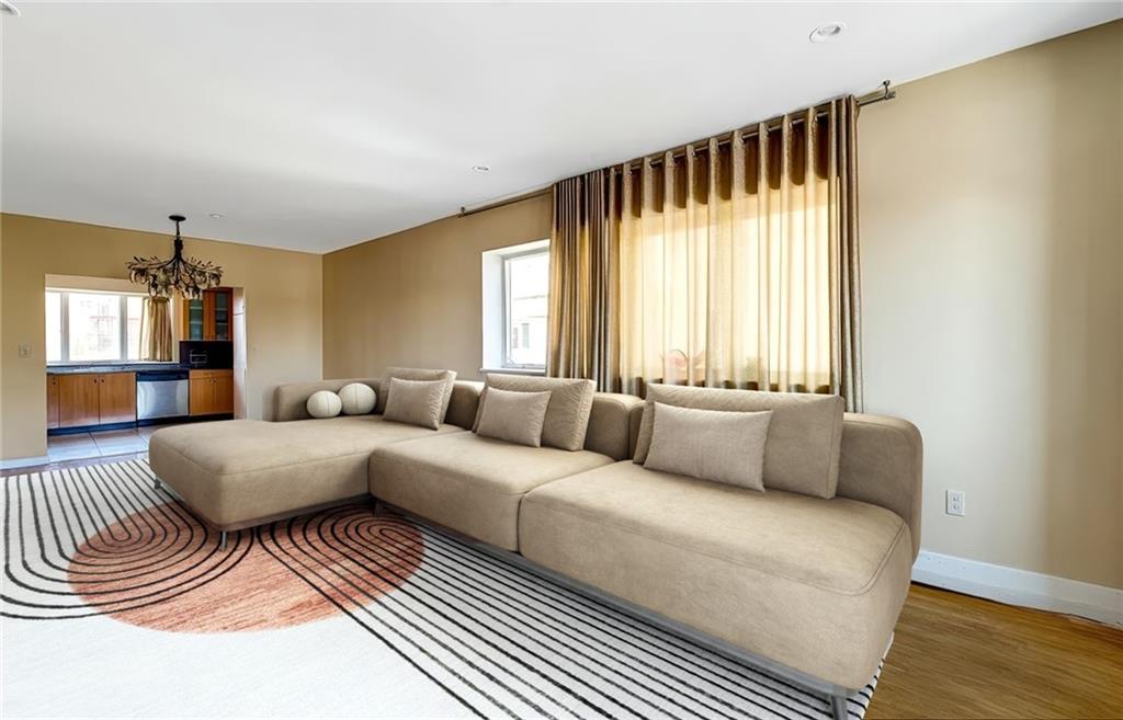 2900 East 29th Street, Unit 2E Brooklyn, NY 11235 - Photo 3 of 17 a living room with furniture and a large window