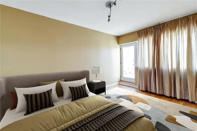 a bedroom with a bed and wooden floor