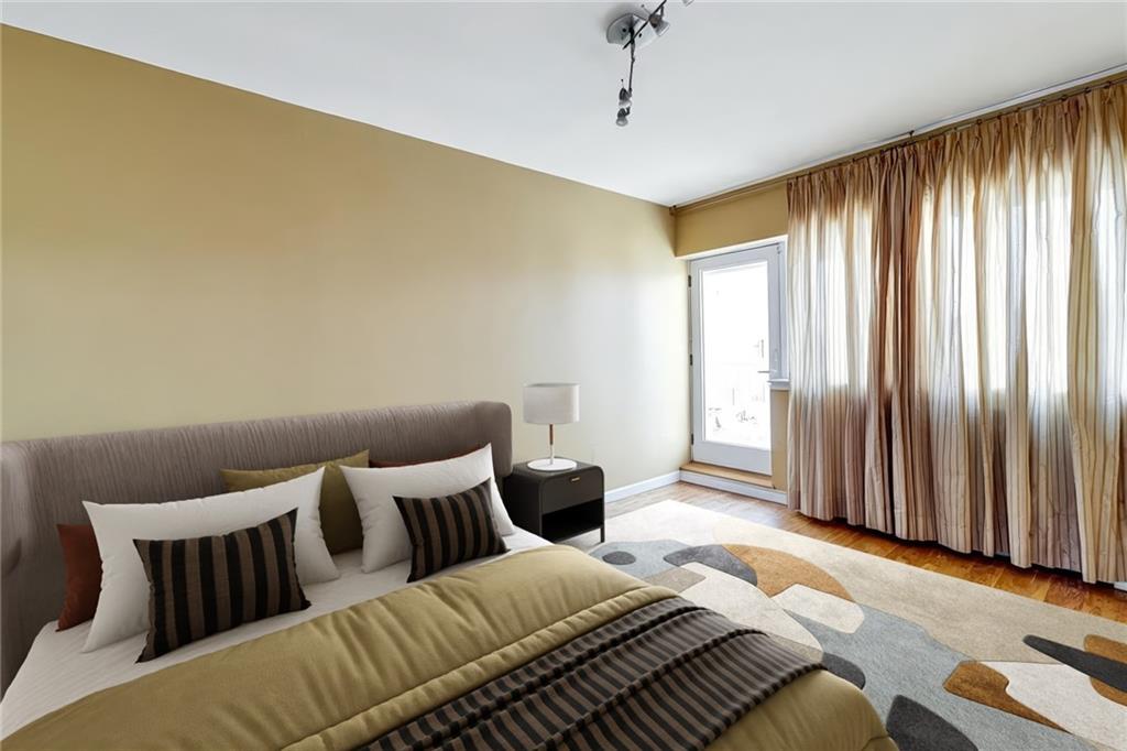 2900 East 29th Street, Unit 2E Brooklyn, NY 11235 - Photo 5 of 17 a bedroom with a bed and wooden floor