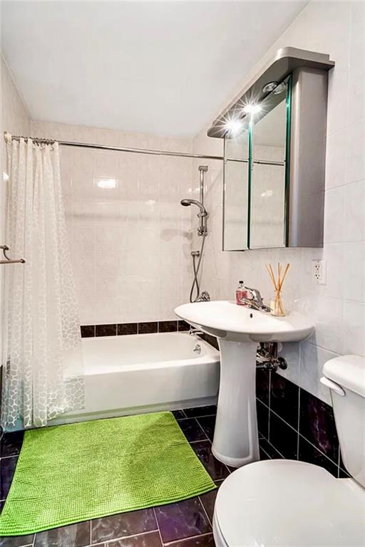 2900 East 29th Street, Unit 2E Brooklyn, NY 11235 - Photo 10 of 17 a bathroom with a sink toilet and mirror