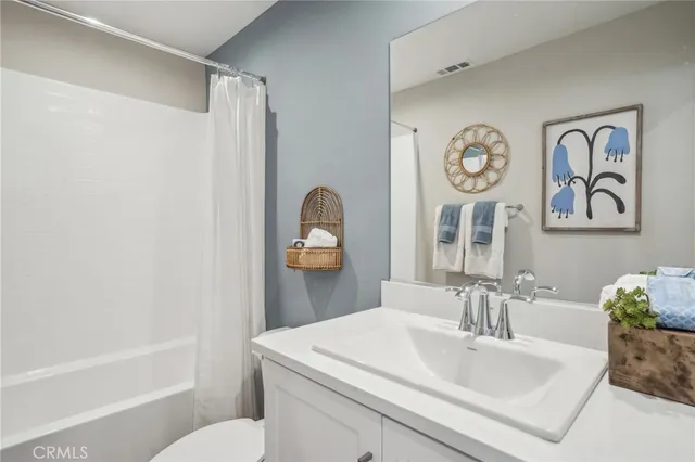 a bathroom with a sink mirror vanity and toilet