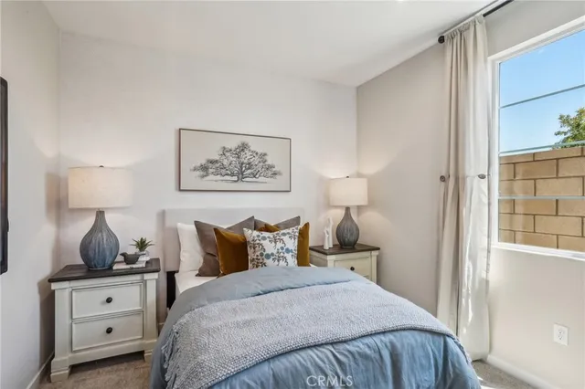 a bedroom with a bed and dressers