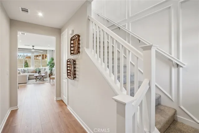 a view of entryway and hall with wooden floor