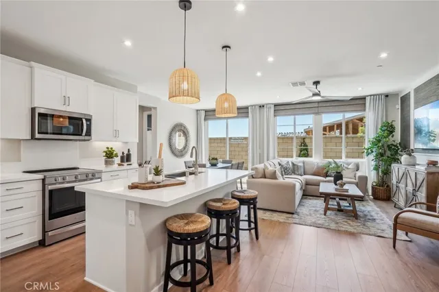 a large kitchen with a table and chairs