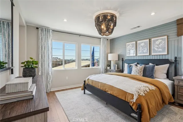 a bedroom with a large bed and a chandelier