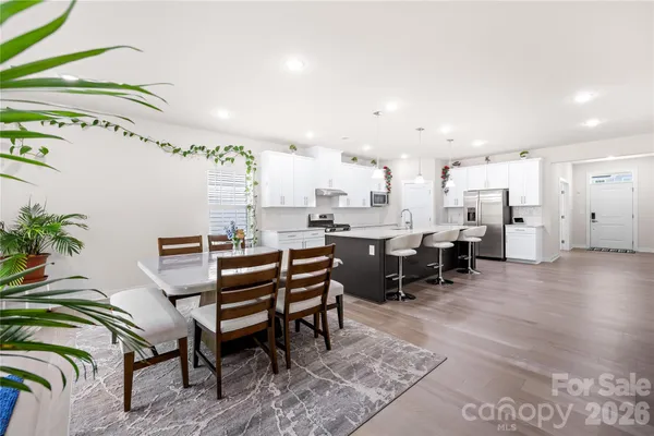 a living room with furniture and kitchen view