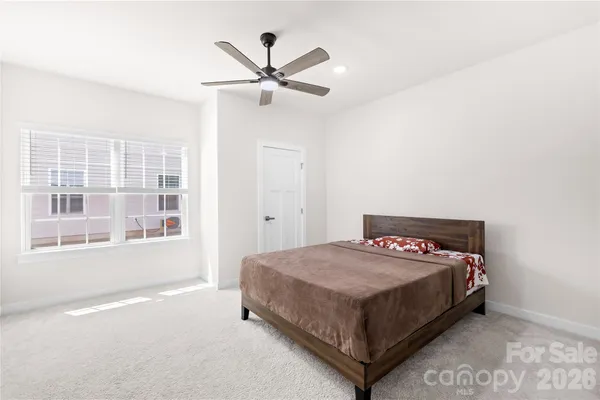 a bedroom with a bed and window