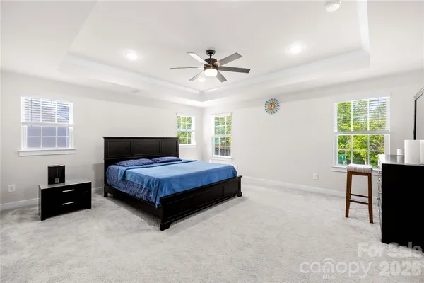 a bedroom with a bed window and a desk