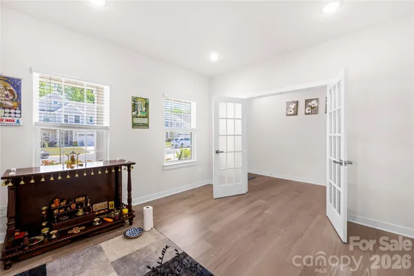 a view of an empty room with a window and fire place