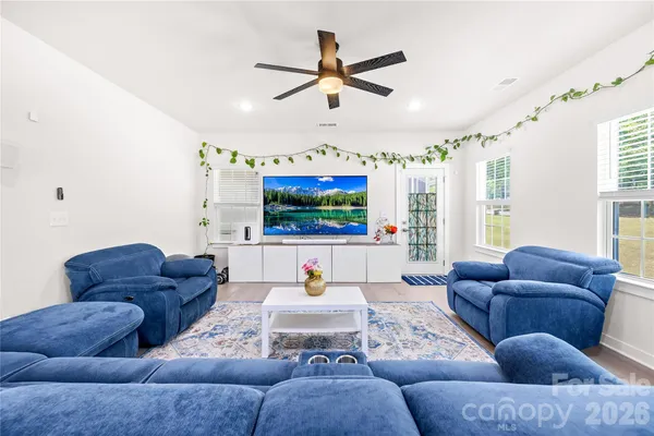 a living room with furniture and a flat screen tv