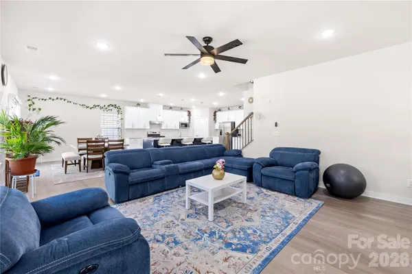 a living room with furniture a rug and a chandelier