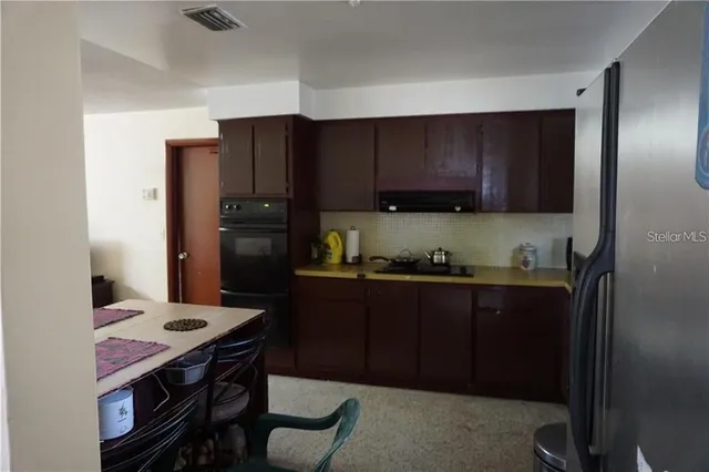 a kitchen with a wooden floor and cabinets