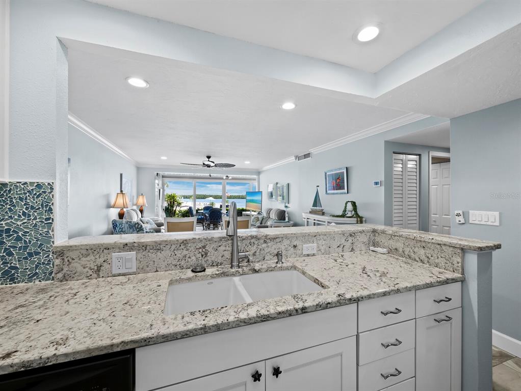 600 Sutton Place, Unit 104B Longboat Key, FL 34228 - Photo 14 of 53 a view living room with granite countertop living room