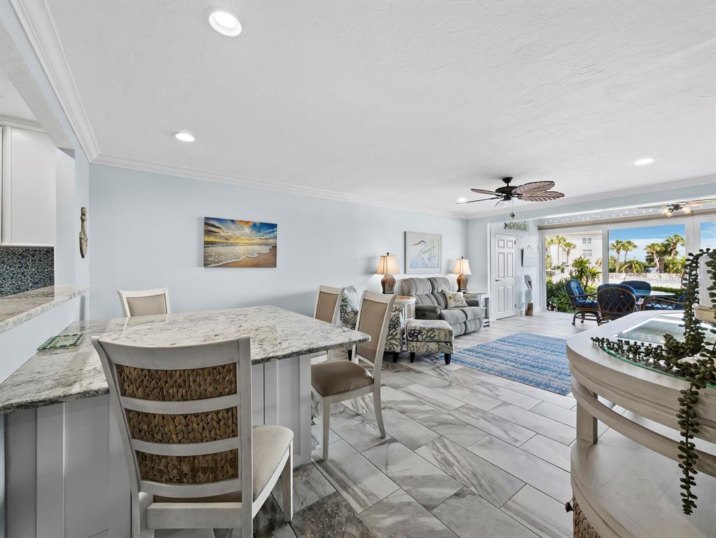 600 Sutton Place, Unit 104B Longboat Key, FL 34228 - Photo 17 of 53 a view of a center island table and chairs