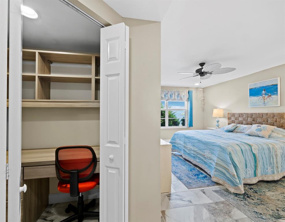 600 Sutton Place, Unit 104B Longboat Key, FL 34228 - Photo 22 of 53 a bedroom with a bed and a chair in it
