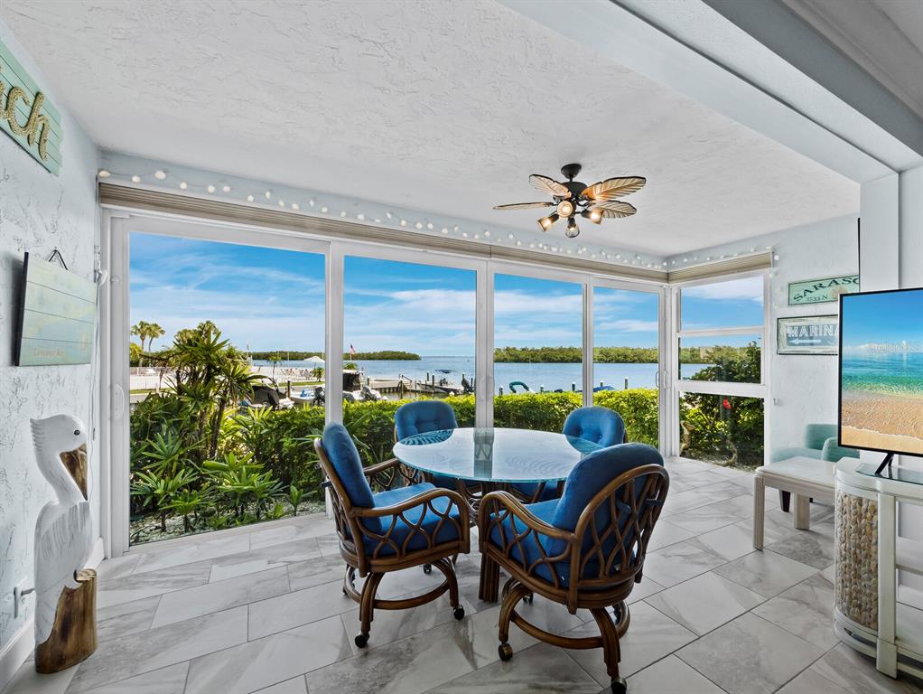 600 Sutton Place, Unit 104B Longboat Key, FL 34228 - Photo 3 of 53 a view of a dining room with furniture window and outside view