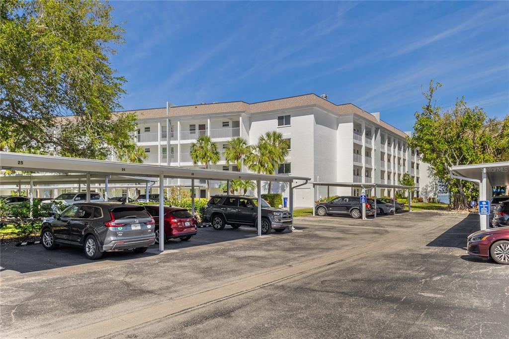 600 Sutton Place, Unit 104B Longboat Key, FL 34228 - Photo 33 of 53 a car parked in front of a building