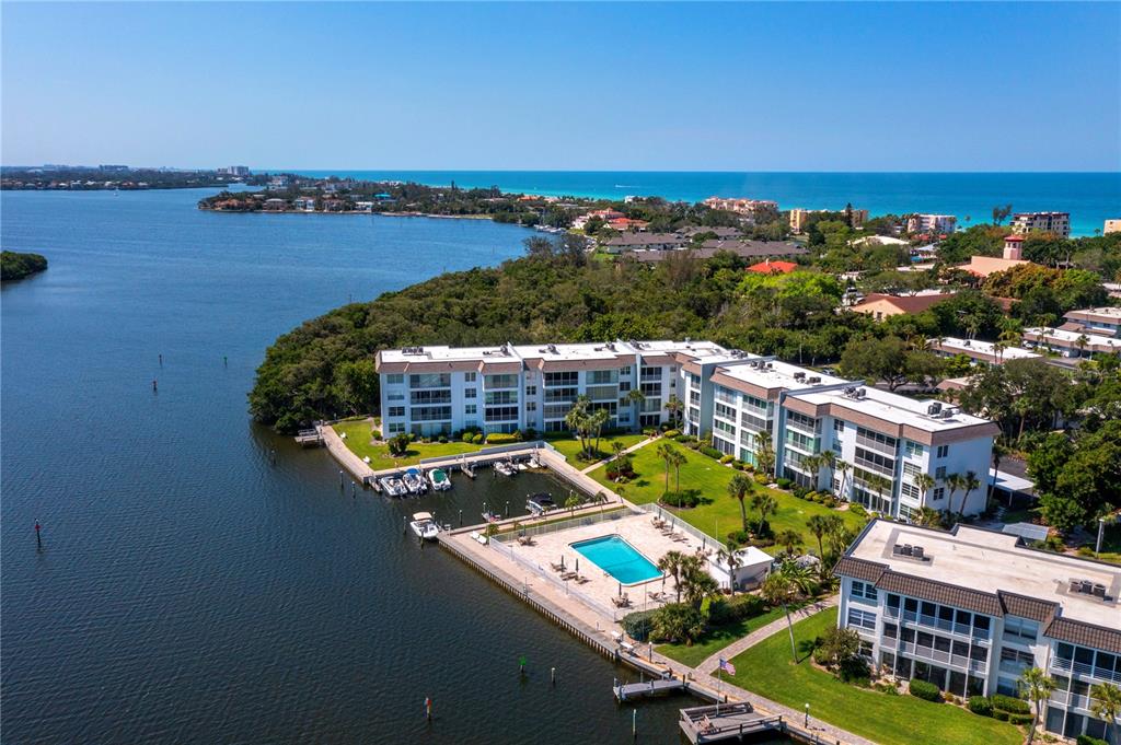 600 Sutton Place, Unit 104B Longboat Key, FL 34228 - Photo 38 of 53 a view of a lake with a building in the background