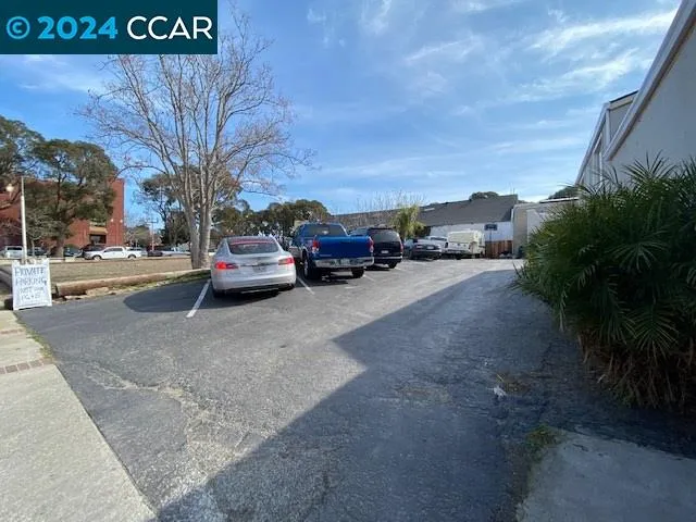 a view of car parked on the side of a street