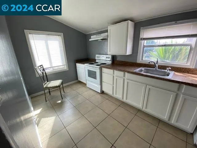 a kitchen with a sink cabinets and window