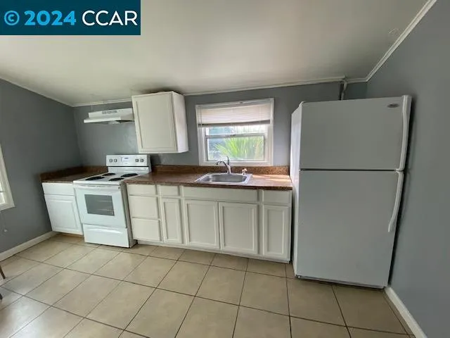 a kitchen with a white cabinets and white appliances
