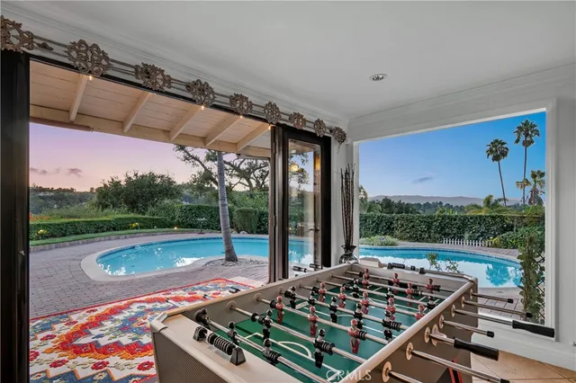 a view of a patio with table and chairs potted plants with wooden floor and fence