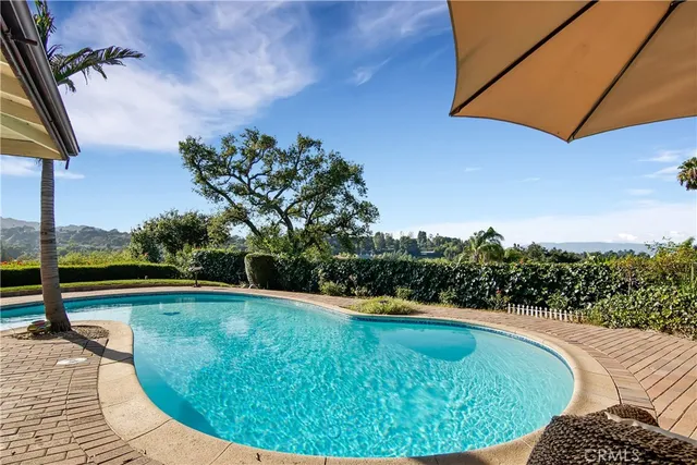 a view of a swimming pool with a yard