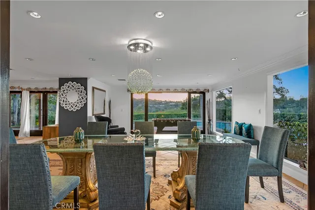 a living room with furniture a flat screen tv and a floor to ceiling window